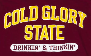 Close-up of Maroon or Burgundy and Gold Collegiate Varsity T-shirt. Distressed printing of college or university  name and Drinking and Thinking sport.