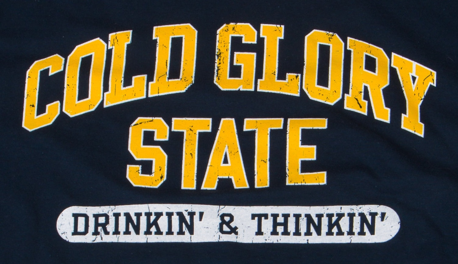 Close-up of Navy and Maize Yellow Collegiate Varsity T-shirt. Distressed printing of college or university  name and Drinking and Thinking sport.