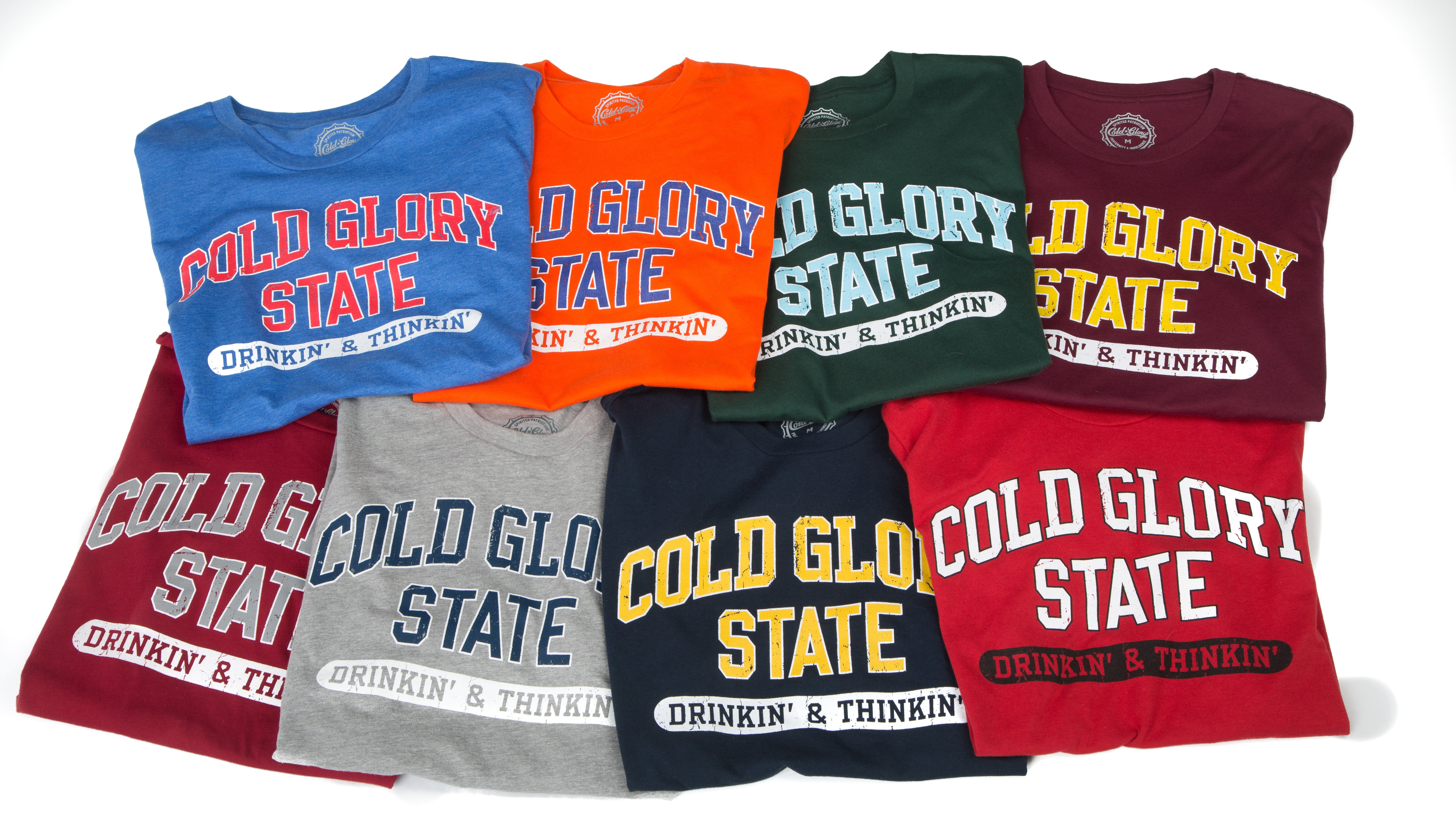 Colorful collegiate varsity t-shirts featuring distressed printing of college name and Drinking and Thinking sport.