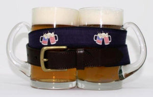 Preppy patriotic beer mugs with american flags drinking belt, with brass buckle similar to Vineyard Vines, wrapped around 2 full glass beer mugs.